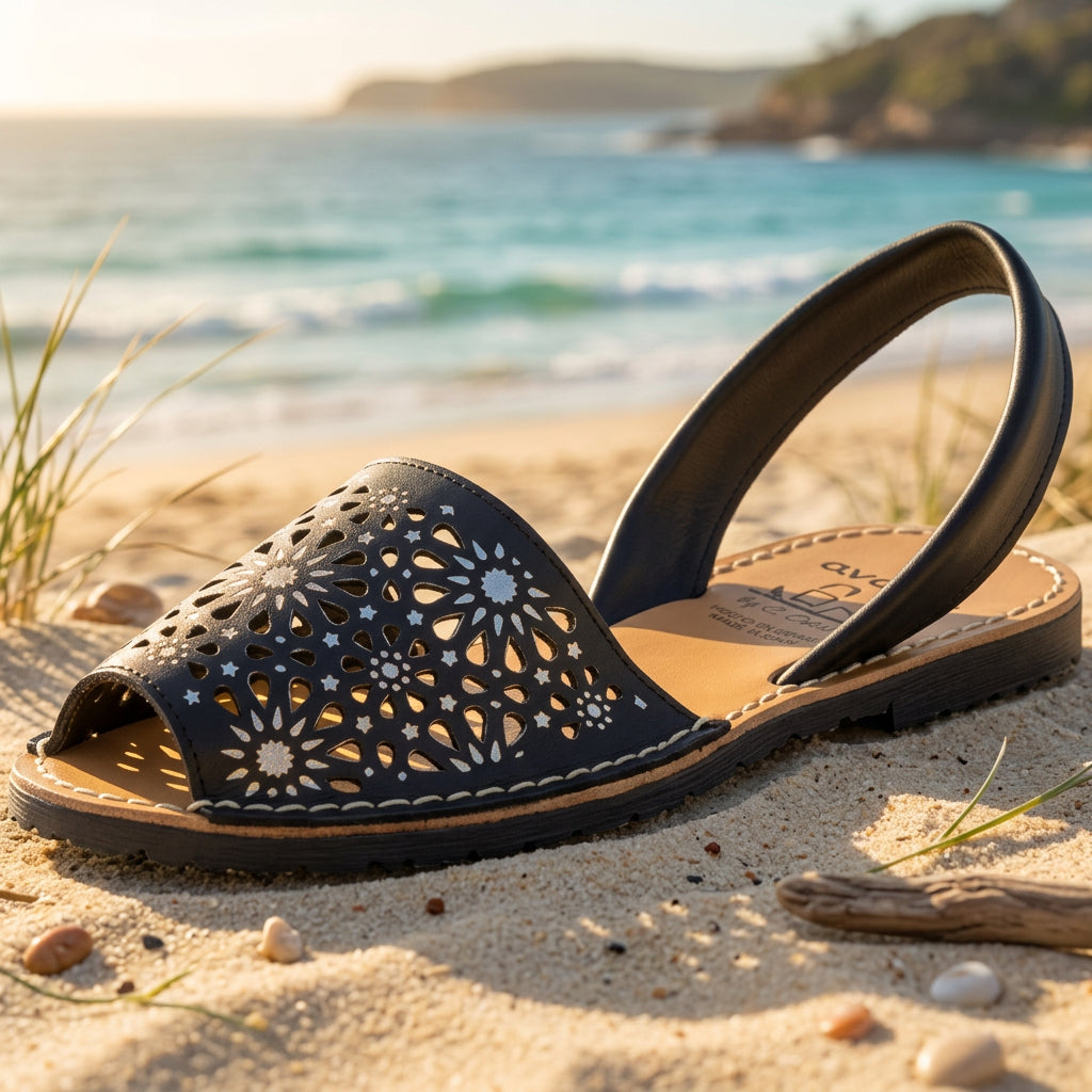 black sandal with silver detail and laser cut pattern